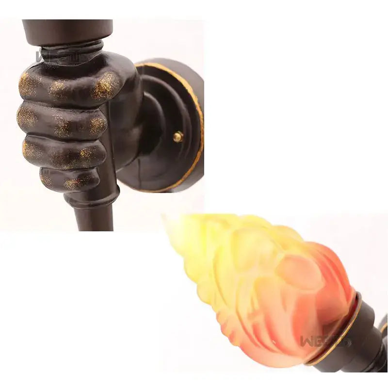 Antique bronze-finished wall lamp with translucent flame-shaped glass diffuser from decorbites creative torch hand series