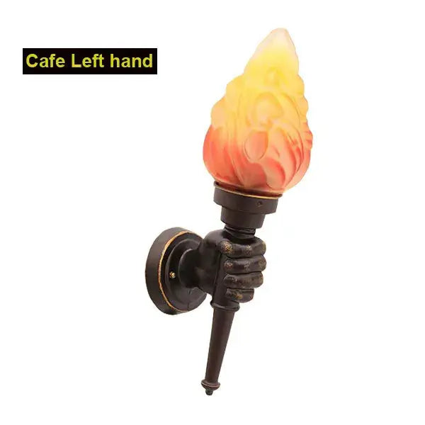 Creative torch hand wall lamp with bronze hand base and amber glass shade for living room decorbites creative torch design