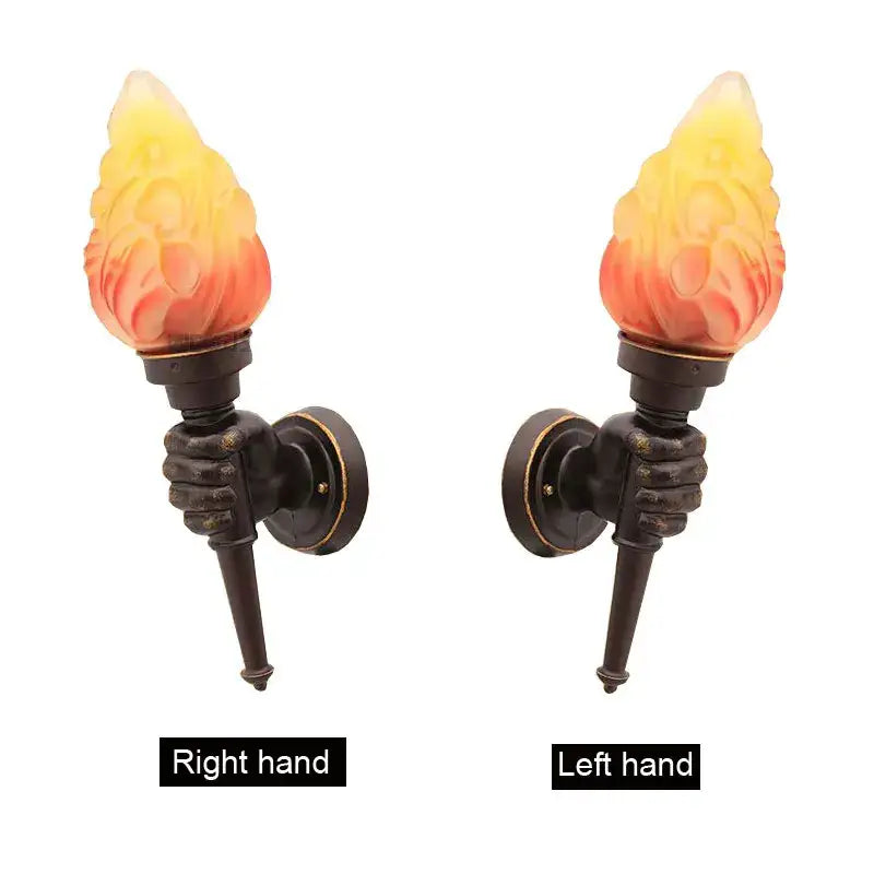 Pair of bronze wall lamps with sculpted hand grips and yellow to orange flame glass shades by decorbites creative torch
