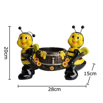 Creative yellow and black bee resin vase featuring figurines holding a wooden barrel planter with sunflowers