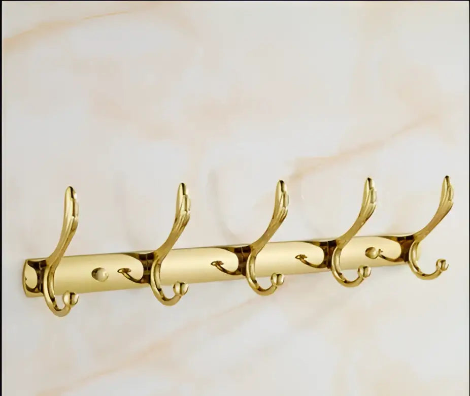 Gold-colored metal coat rack with five ornate curved hooks from decorbites brass bathroom accessories set