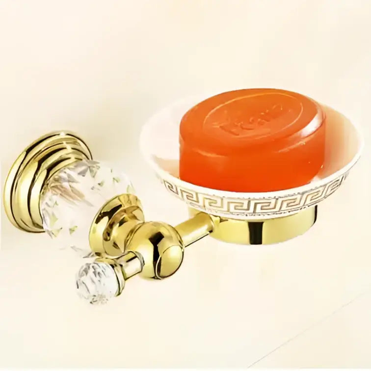 Gold-finished crystal bathroom accessories soap dish with white bowl, greek key pattern, and decorbites brass knobs