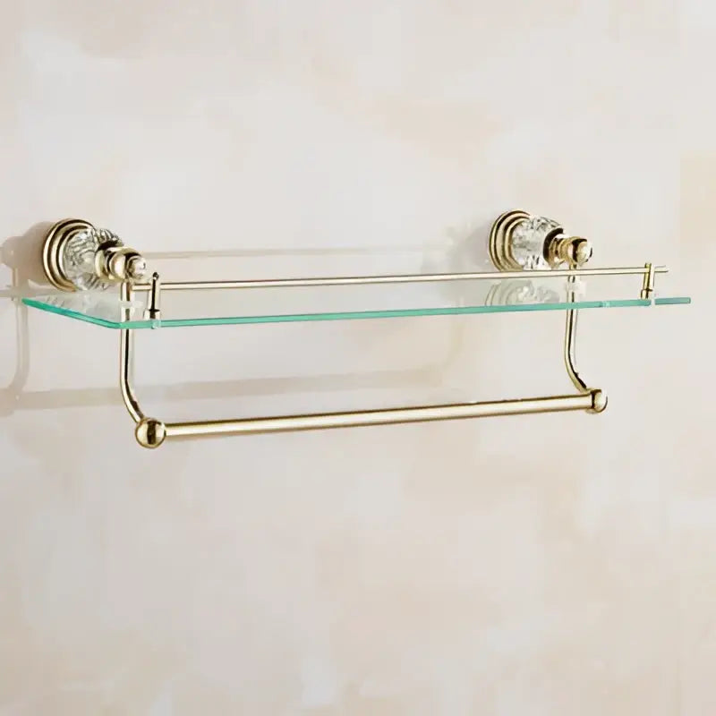 Gold-toned crystal bathroom accessories set with clear glass shelf and decorative crystal accents by decorbites brass