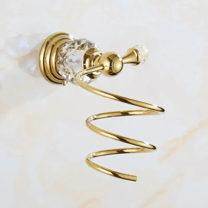 Gold-toned spiral towel rack with crystal accents and polished brass finish in crystal bathroom accessories set by decorbites brass