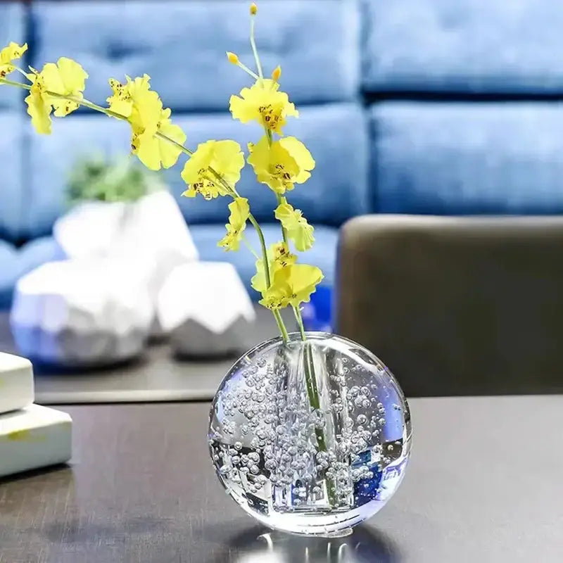 Clear spherical glass crystal bubble ball vase with vibrant yellow artificial flowers for decorbites desk decor