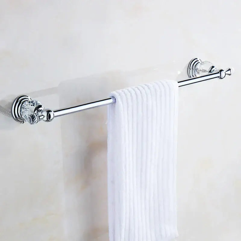 Chrome finished crystal chrome towel bar with faceted accent holding a white ribbed towel by decorbites crystal chrome