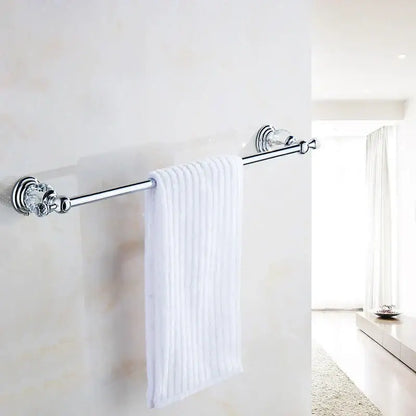 Chrome-finished decorbites crystal chrome towel bar with faceted crystal chrome towel ends holding white ribbed towel