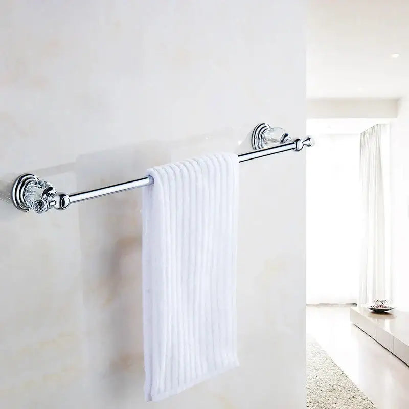 Chrome-finished decorbites crystal chrome towel bar with faceted crystal chrome towel ends holding white ribbed towel