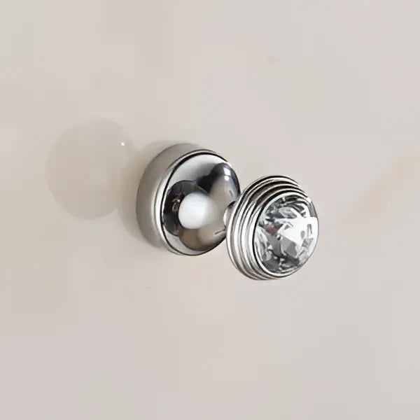 Silver-toned showerhead with faceted crystal accent and ribbed metallic finish in decorbites crystal chrome wall hook set