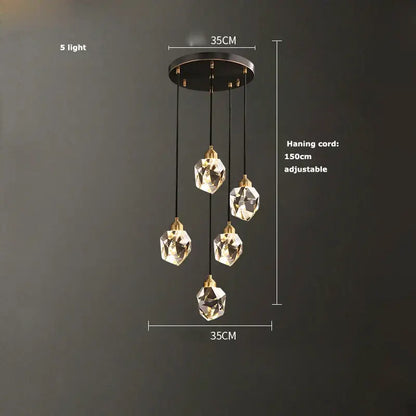 A modern decorbites crystal copper chandelier with five clear glass pendant lights and black circular mount for dining room lighting