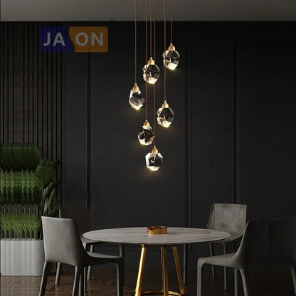 A modern decorbites crystal copper chandelier with gold and black geometric metal accents and faceted glass shades