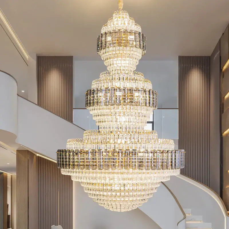 A multi-tiered decorbites crystal duplex chandelier with gold-toned accents for elegant hotel lobby lighting