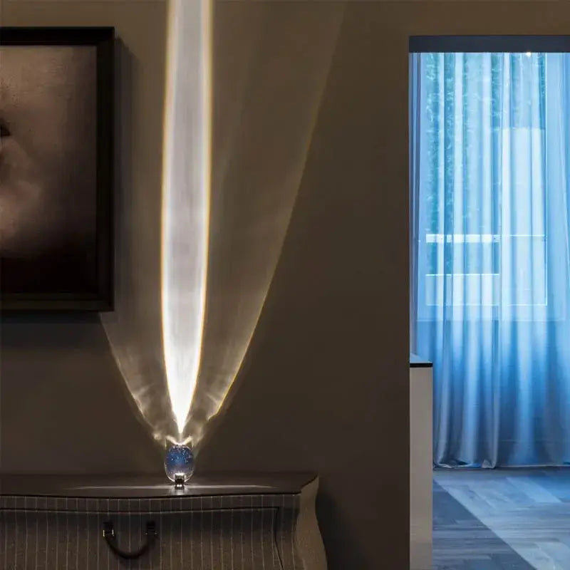 A sleek decorbites crystal eye sky led table lamp with metallic base and glass dome casting warm focused light