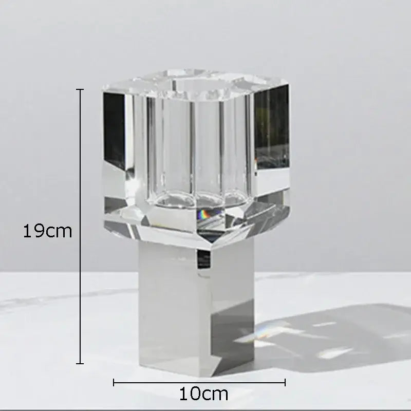 Crystal clear glass candle holder with faceted design and sleek silver base for elegant living room decor