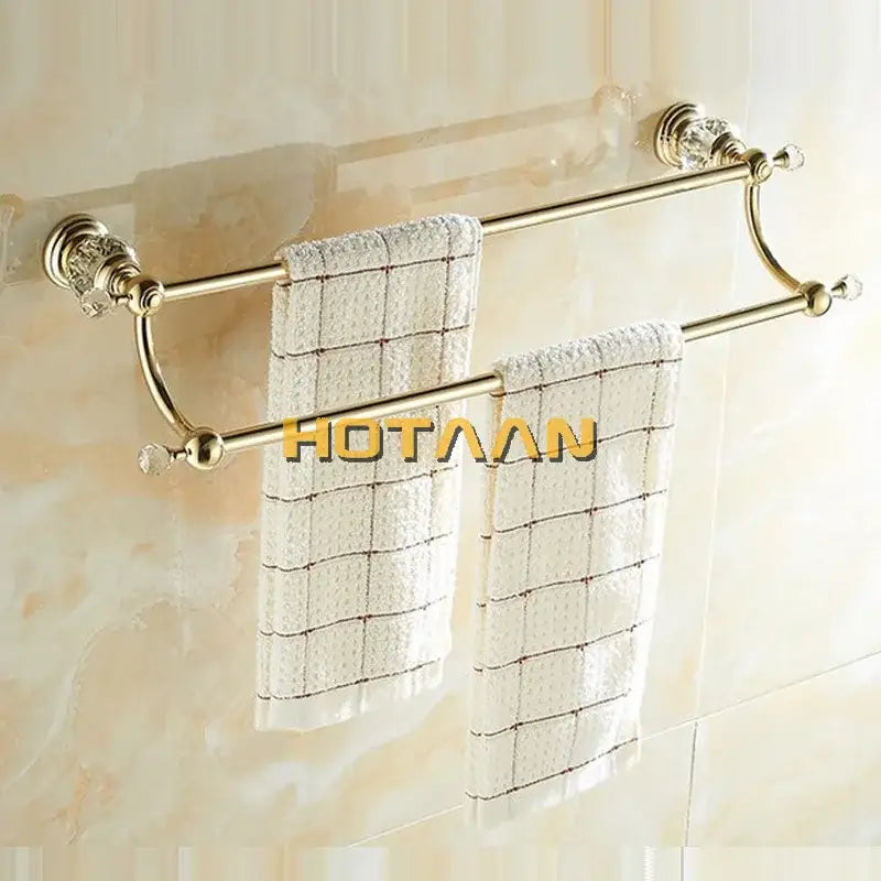 Crystal gold double towel bar with crystal accents holding white checkered towels for bathroom organization