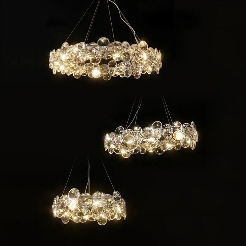 Three tiered decorbites crystal magic ring pendant light with clear glass orbs refracting warm light for dining room decor