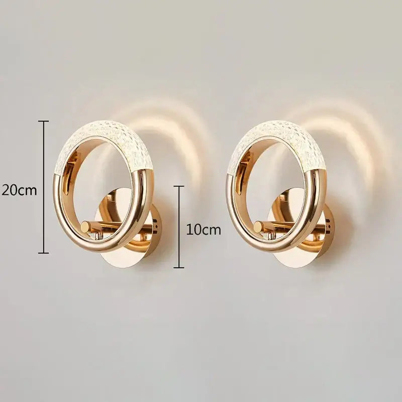 Gold-toned crystal nordic wall sconce with textured white crystal upper ring and polished metal lower band for bedroom decorbites