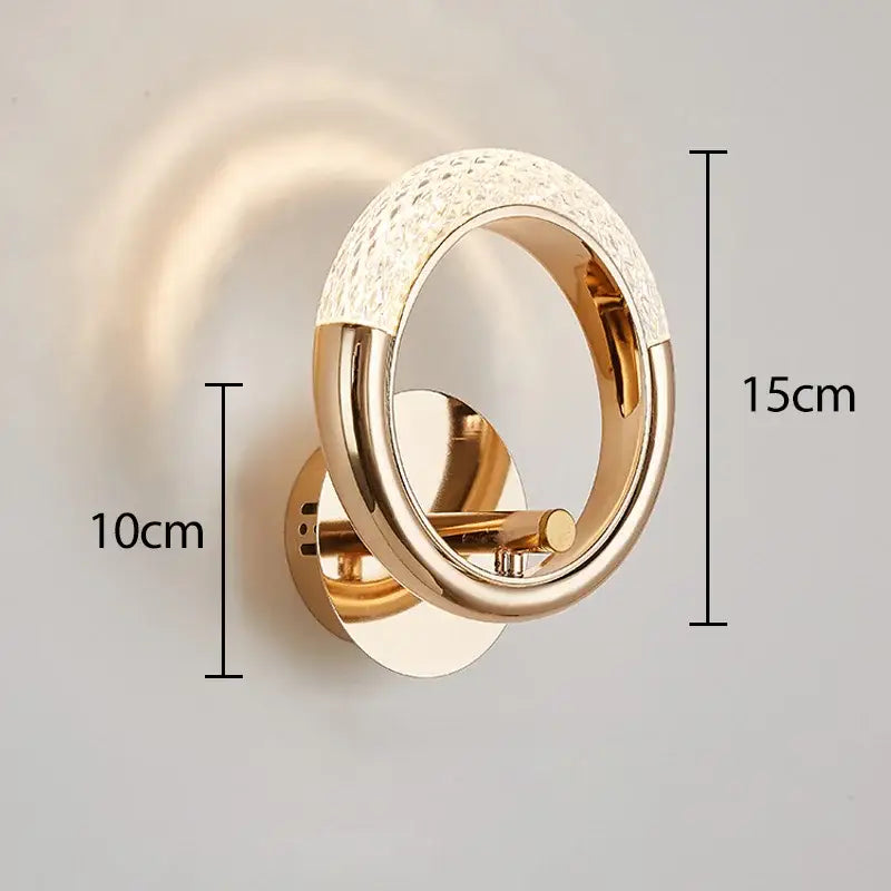 Gold-toned decorbites crystal nordic wall sconce with circular design and sparkling crystal embellishments for bedroom light