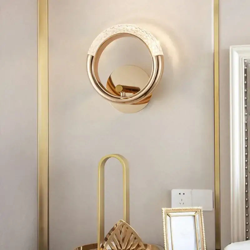 Gold-toned crystal nordic wall sconce with textured beaded ring and polished metallic finish for bedroom decorbites lighting