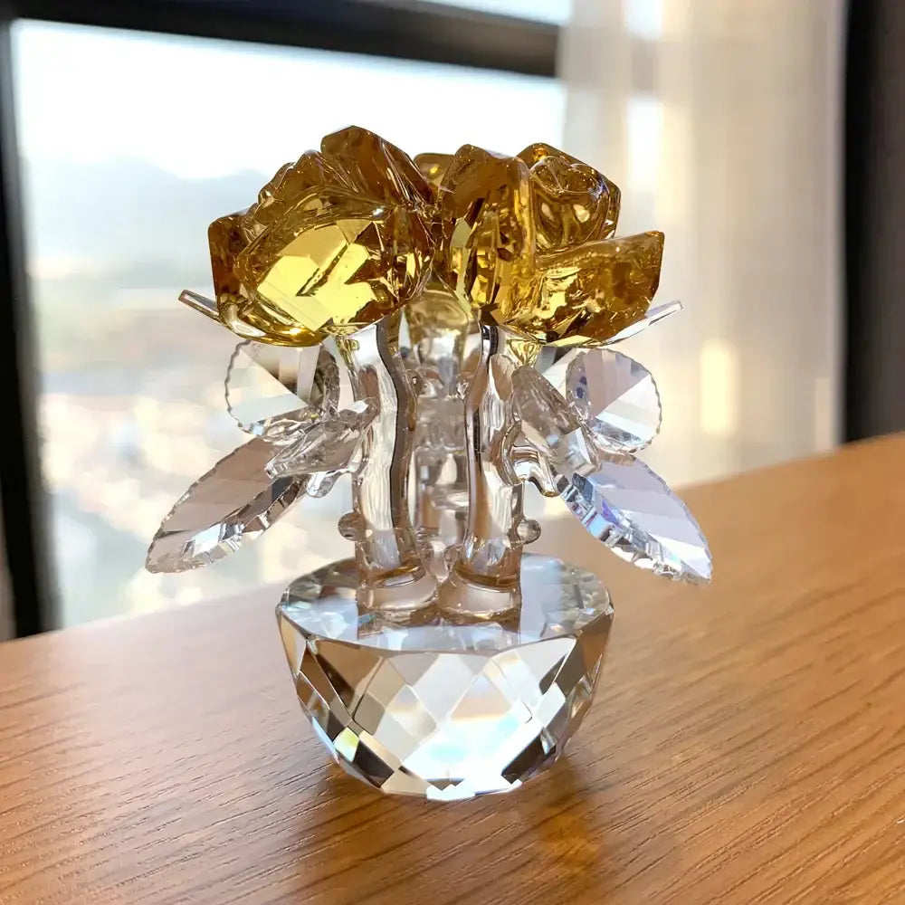 A sparkling crystal rose flower dreams glass paperweight bouquet with golden petals and faceted leaves in a diamond base