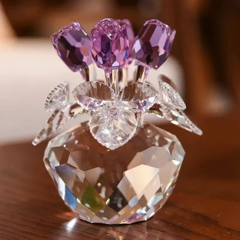 A sparkling crystal vase with faceted purple tulips and clear glass leaves in a rose flower dreams paperweight bouquet