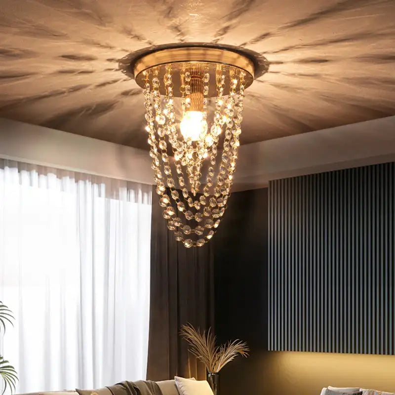 A golden ceiling light chandelier with cascading crystal beads from decorbites crystal sun flower collection