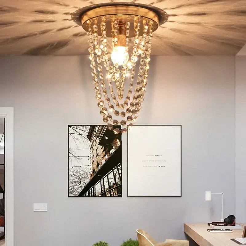 A golden crystal sun flower ceiling light with cascading beads from decorbites emits a warm bedroom glow