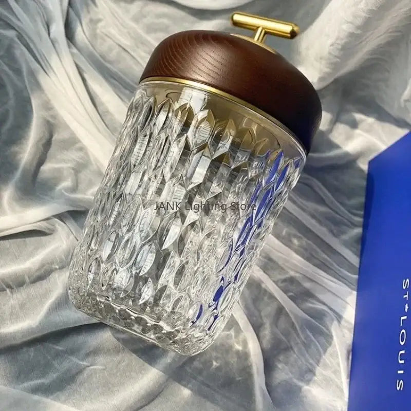 Crystal table lamp with a clear diamond-cut glass jar and dark brown wooden lid for bedroom night light