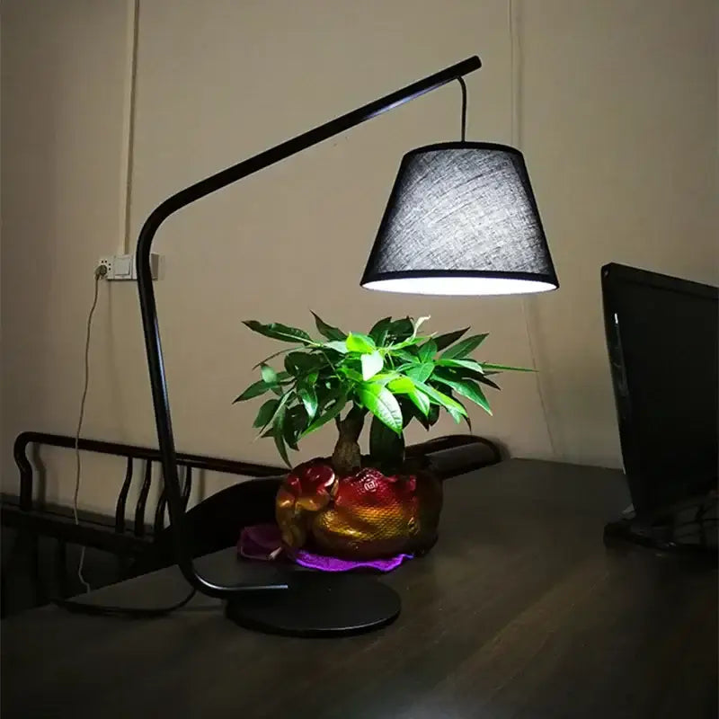 Curved matte black led floor lamp with a textured gray fabric shade for living room and bedroom lighting