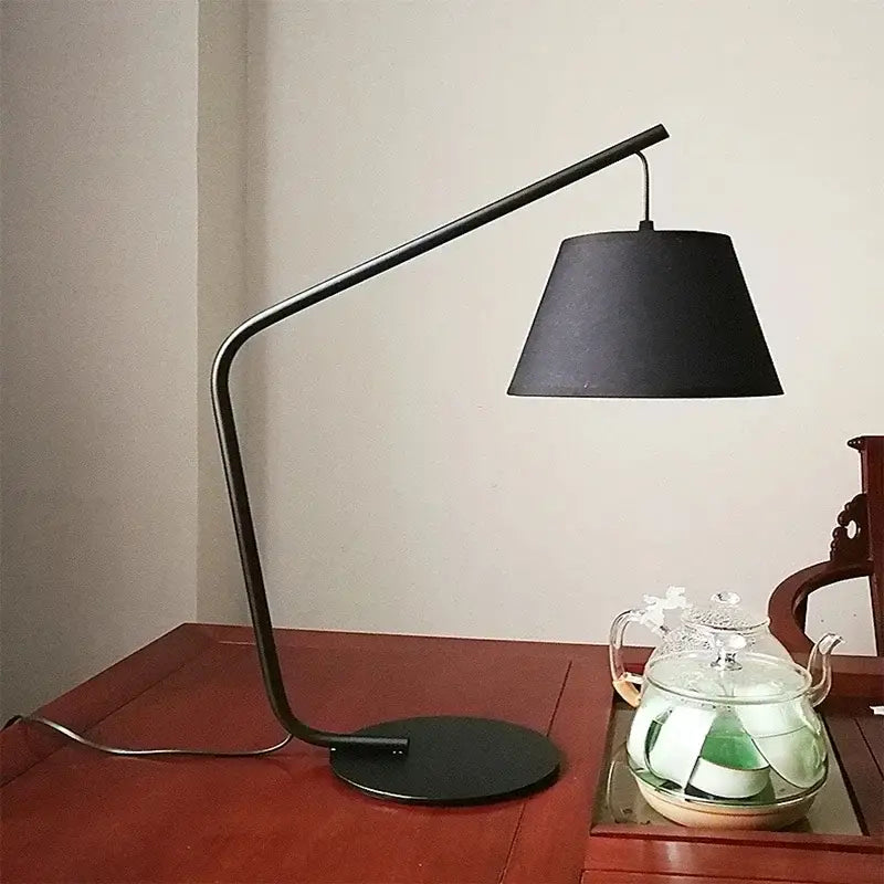 Black metal led floor lamp with sleek curved arm and matte conical shade for living room and bedroom lighting