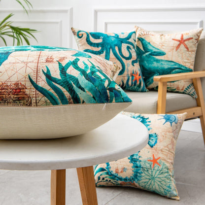 Cream-colored cushion with blue and green ocean-themed designs, including starfish and coral.