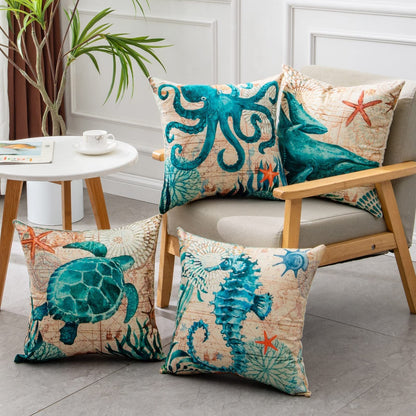 Beach-themed throw pillow set with sea creatures and starfish design, featuring a turtle, octopus, seahorse, and coral motifs in teal blue and beige tones on cotton fabric.