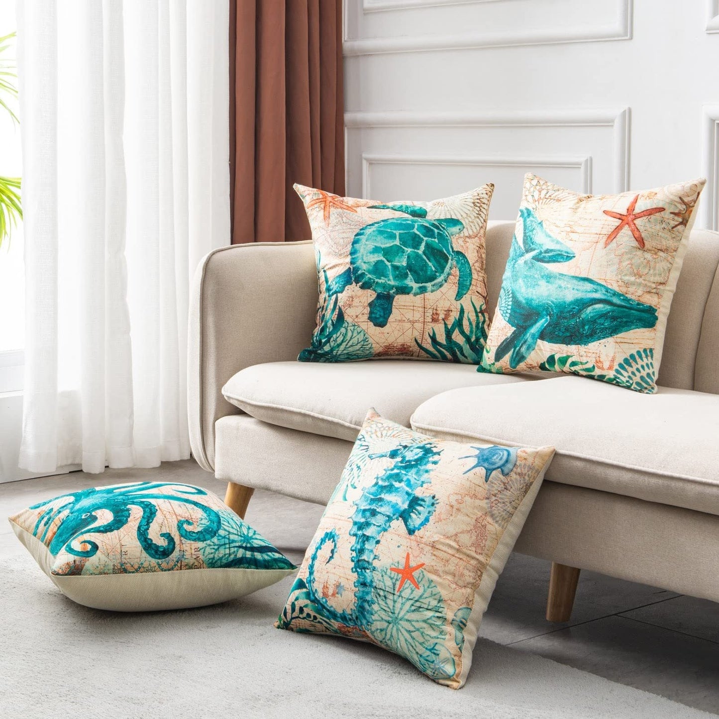 Beach-themed throw pillow set with sea turtle and starfish design, beige background, teal accents, cotton blend material.