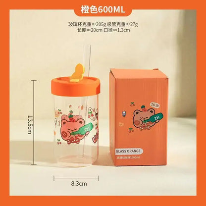 Orange-themed glass cup with a cartoon bear design and orange lid featuring yellow straw from decorbites cartoon glass collection