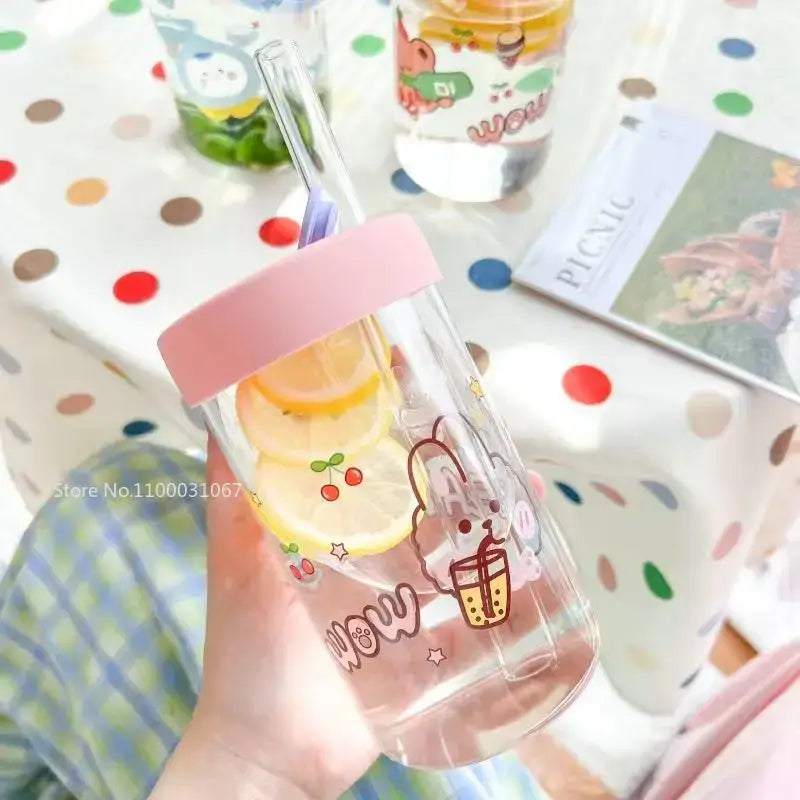 Clear glass cup with pink lid featuring cute bear cartoon holding bubble tea decorated with lemon and cherry decorbites cartoon glass