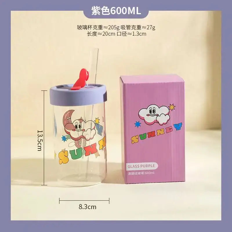 A clear glass cup with purple lid and straw featuring a pink blue and yellow cartoon moon decorbites cartoon glass