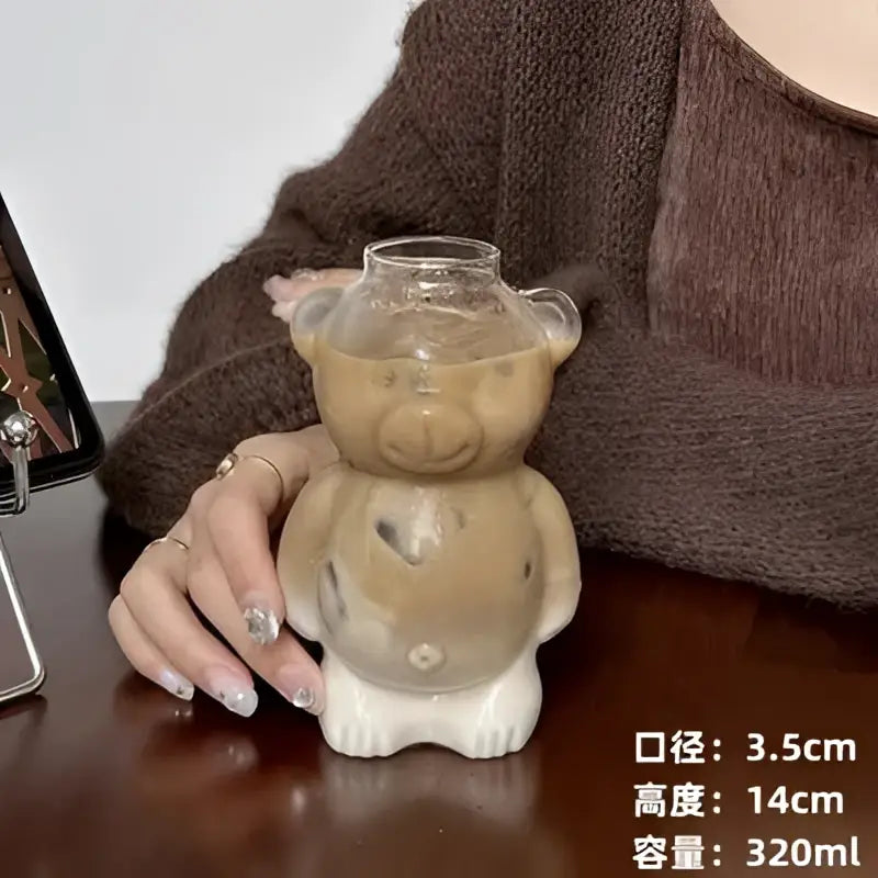 Translucent frosted beige bear glass cup with ceramic base featuring clear glass head small ears and paws for kitchen use