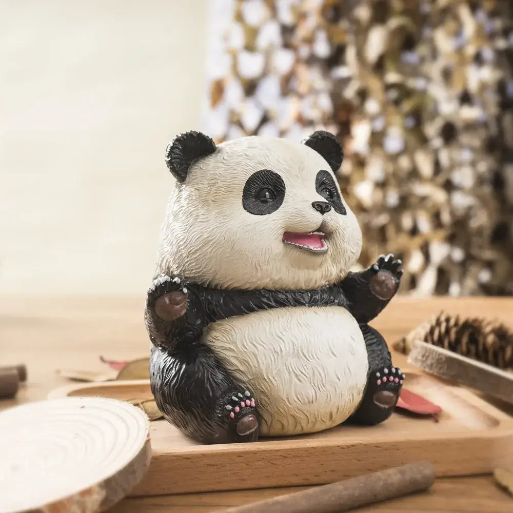 Cute black and white panda baby figurine with textured fur sitting on a wooden surface for living room decor