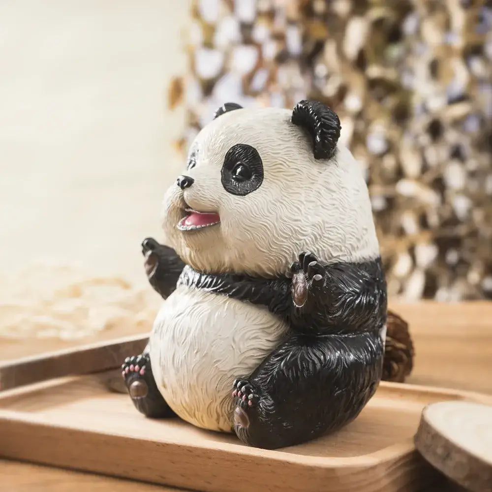 Adorable black and white panda baby figurine with textured fur details sitting on wooden tray for living room decor