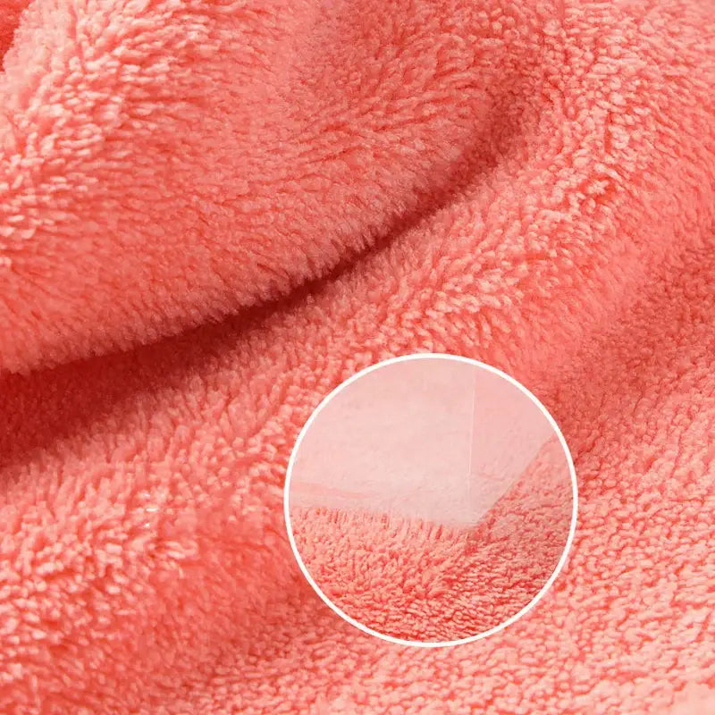 Soft coral-colored plush coral fleece hand towel with cozy texture featuring a cute cartoon animal design