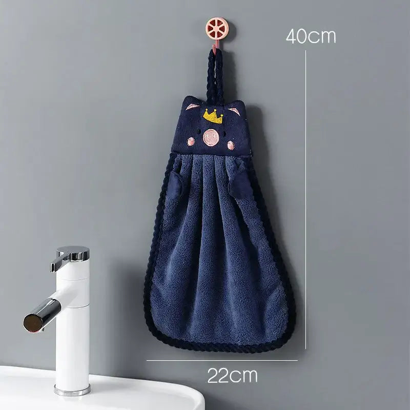 Navy blue plush cat-themed hand towel with embroidered crown and pink cheeks hanging on wooden hook for decorbites cartoon animal hand use