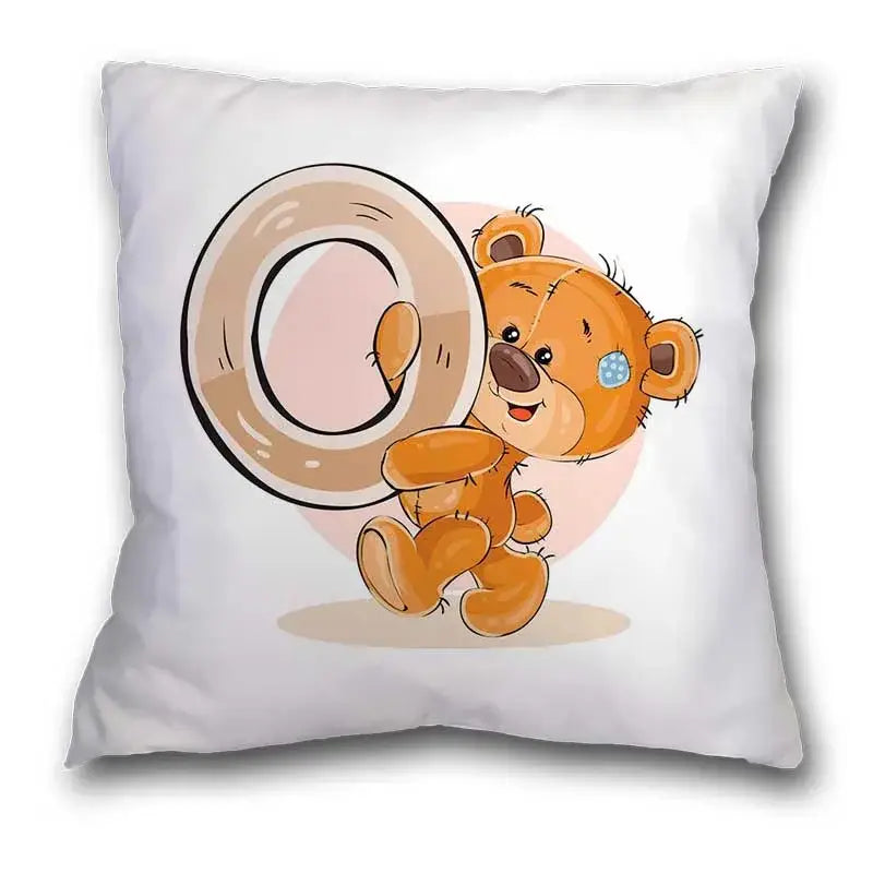 White pillow case with a cute cartoon bear animal holding a beige letter o for bedroom decor