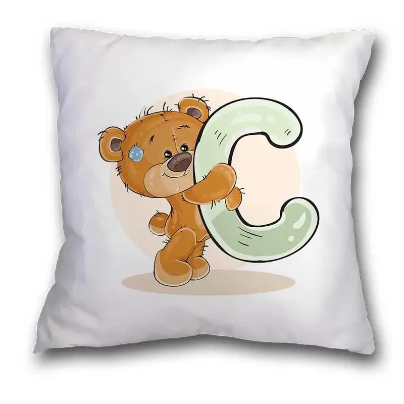 White pillow case featuring a cute cartoon bear holding a light green letter c for bedroom decor