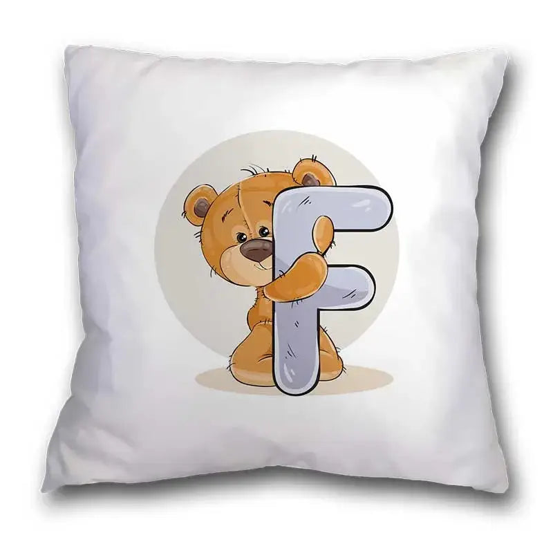 White pillow case with a cute cartoon bear animal holding letter f on soft beige background for bedroom decor
