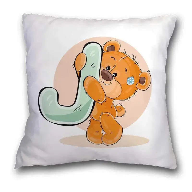 White pillow case featuring a cute cartoon bear animal illustration of an orange teddy bear holding a light green letter j