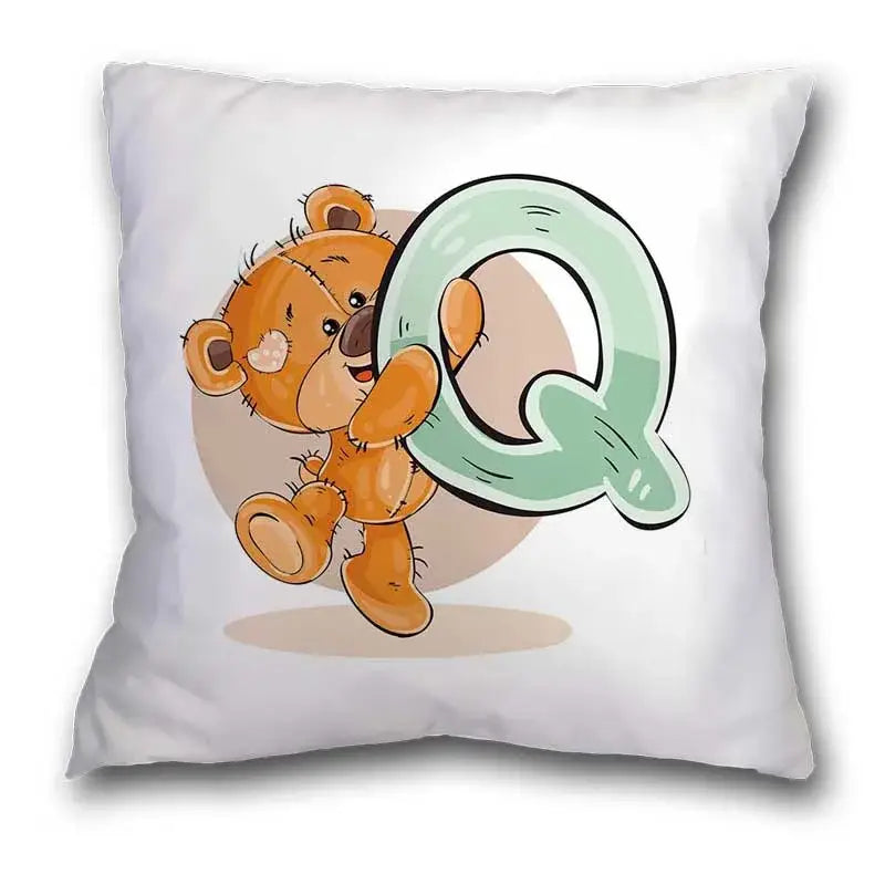 White pillow case featuring a cute cartoon bear animal holding a mint green letter q for bedroom decor