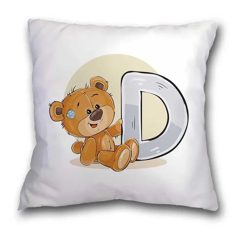 White throw pillow case featuring a cute cartoon bear animal with blue eye patch beside a large silver letter d