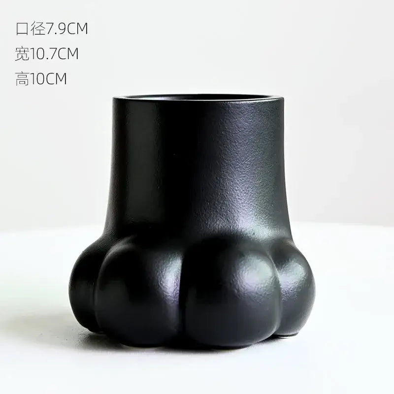 Black ceramic planter shaped like a cute cartoon cat paw print for living room decor vase set