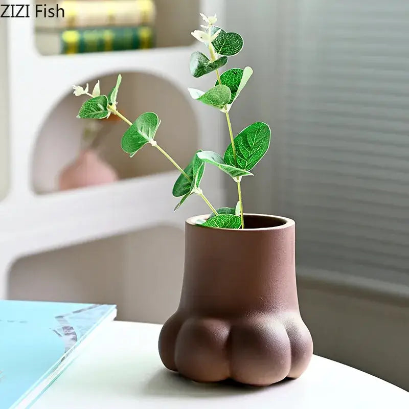 Brown ceramic planter shaped like a cute cartoon cat paw for living room decor and flower vase set