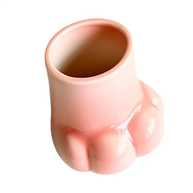 A glossy pink ceramic cup shaped like a cute cartoon cat paw for living room decor vase set